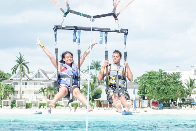 Parasailing, Blue Hole Mineral Spring, Seven Mile Beach - Seven Mile Beach beyond the parachute